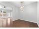 A dining room with hardwood floors, a chandelier, and access to the back patio at 4236 Silver Spruce Ln, Smyrna, GA 30080