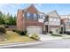 A charming two-story brick townhome featuring an attached garage and well-maintained landscaping at 4236 Silver Spruce Ln, Smyrna, GA 30080