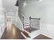 A welcoming foyer featuring hardwood floors and an elegant staircase with iron spindles at 4236 Silver Spruce Ln, Smyrna, GA 30080