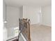 Upstairs hallway featuring a staircase with metal railing and a view of the entry at 4236 Silver Spruce Ln, Smyrna, GA 30080