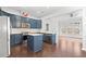 A modern kitchen featuring blue cabinets, stainless steel appliances, and a center island at 4236 Silver Spruce Ln, Smyrna, GA 30080