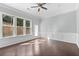 Spacious living room with hardwood floors, large windows, and door leading to the outside at 4236 Silver Spruce Ln, Smyrna, GA 30080
