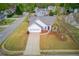 Aerial view of a lovely single-Gathering home showcasing its manicured lawn, mature trees, and proximity to a quiet residential street at 1193 Colony Creek Ct, Lawrenceville, GA 30043