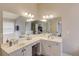 Bathroom with double vanity, large mirrors, garden tub, and neutral color palette creates a serene and functional space at 1193 Colony Creek Ct, Lawrenceville, GA 30043
