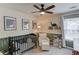 Adorable Bedroom with dinosaur decor, ceiling fan, a black crib, and a comfortable chair at 1193 Colony Creek Ct, Lawrenceville, GA 30043
