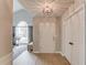 A bright entryway featuring wood floors, textured ceilings, and a view into the adjacent living area with large windows at 1193 Colony Creek Ct, Lawrenceville, GA 30043