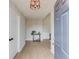 Inviting entryway with light wood floors, neutral walls, a modern light fixture, and a glimpse into other rooms at 1193 Colony Creek Ct, Lawrenceville, GA 30043