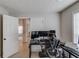 View of a home office with multiple monitors, desk, and a view to the living area at 1193 Colony Creek Ct, Lawrenceville, GA 30043