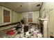 Damaged bedroom with debris, peeling paint, and a non-functional fireplace at 1366 Sylvan Sw Rd, Atlanta, GA 30310