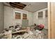 Dilapidated bedroom filled with debris, damaged walls, and boarded up windows at 1366 Sylvan Sw Rd, Atlanta, GA 30310