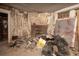 Renovation opportunity: Room with fireplace, exposed walls, and debris needing repair at 1366 Sylvan Sw Rd, Atlanta, GA 30310