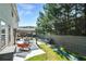 A backyard patio with seating under a pergola, a well-manicured lawn and a bench at 3798 Broadleaf Walk, Snellville, GA 30039