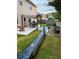 Backyard patio with seating, pergola, manicured lawn and a bench at 3798 Broadleaf Walk, Snellville, GA 30039