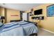 A cozy bedroom with a large bed, TV, and decor at 3798 Broadleaf Walk, Snellville, GA 30039