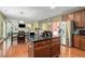 Open kitchen layout with island seating and a view to the dining and living areas at 3798 Broadleaf Walk, Snellville, GA 30039