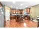 Well-equipped kitchen with a center island, wood cabinets, and stainless steel appliances at 3798 Broadleaf Walk, Snellville, GA 30039