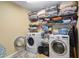 Spacious laundry room with front loading washer and dryer and wire shelving at 3798 Broadleaf Walk, Snellville, GA 30039