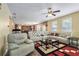 Bright and open living room flows to a kitchen, with large sofa and neutral walls at 3798 Broadleaf Walk, Snellville, GA 30039