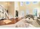 Elegant living room with high ceilings, large windows, and hardwood floors at 3798 Broadleaf Walk, Snellville, GA 30039