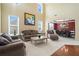 Spacious living room showcasing a two-story ceiling and a view to the dining area at 3798 Broadleaf Walk, Snellville, GA 30039