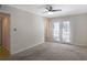 Unfurnished bedroom with french doors to the balcony, a ceiling fan, and ensuite bath at 1445 Monroe Ne Dr # C6, Atlanta, GA 30324