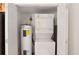 Laundry room featuring a stacked washer and dryer unit, and a water heater, providing efficient space-saving solutions at 1445 Monroe Ne Dr # C6, Atlanta, GA 30324