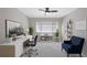 Home office with a large window, modern desk, comfortable chair, and stylish decor at 1445 Monroe Ne Dr # C6, Atlanta, GA 30324