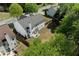 Aerial view showcasing the house, backyard, and surrounding neighborhood with lush greenery at 3452 Hard Creek Ln, Buford, GA 30519
