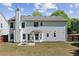 Back of the house featuring white siding, a patio, and well-maintained landscaping in the backyard at 3452 Hard Creek Ln, Buford, GA 30519