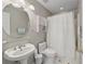 Well-lit bathroom featuring a pedestal sink, an oval mirror, and a shower with a white curtain at 3452 Hard Creek Ln, Buford, GA 30519