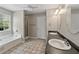 Bathroom featuring a soaking tub, a shower, tile floors, and a double sink vanity at 3452 Hard Creek Ln, Buford, GA 30519