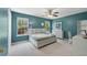 Serene bedroom with turquoise walls, a spacious window view, and ample natural light at 3452 Hard Creek Ln, Buford, GA 30519