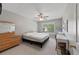Bright bedroom featuring neutral tones, a ceiling fan, and a large window for ample natural light at 3452 Hard Creek Ln, Buford, GA 30519