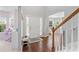 Bright foyer with hardwood floors, a white front door, and access to multiple rooms at 3452 Hard Creek Ln, Buford, GA 30519