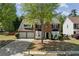 Charming two-story brick home with a two-car garage, landscaped yard, and classic black shutters at 3452 Hard Creek Ln, Buford, GA 30519