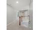 Hallway with white trim and doors and carpet leading to bedrooms and bathrooms on the second floor at 3452 Hard Creek Ln, Buford, GA 30519