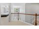 Hallway with white trim and doors and carpet leading to bedrooms on the second floor of the home at 3452 Hard Creek Ln, Buford, GA 30519