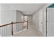 Light and bright hallway with carpet and white trim and doors leading to bedrooms and bathrooms at 3452 Hard Creek Ln, Buford, GA 30519