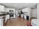 Well-lit kitchen featuring stainless steel appliances, white cabinetry, and a functional layout at 3452 Hard Creek Ln, Buford, GA 30519