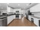 Bright kitchen with stainless steel appliances, a breakfast bar, and white cabinetry at 3452 Hard Creek Ln, Buford, GA 30519