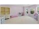 Spacious playroom with neutral carpet, a built-in bookcase, and natural light from large windows at 3452 Hard Creek Ln, Buford, GA 30519