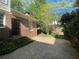 Beautiful backyard with a small patio, flower petal covered ground, and plenty of landscaping at 629 Pinetree Dr, Decatur, GA 30030