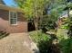 Brick home with a garden featuring a birdbath and flower petals on the patio at 629 Pinetree Dr, Decatur, GA 30030