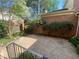 Charming backyard featuring a patio area surrounded by brick walls, greenery, and manicured landscaping at 629 Pinetree Dr, Decatur, GA 30030