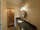 Bathroom featuring granite countertops, a shower with glass door, and decorative lighting at 629 Pinetree Dr, Decatur, GA 30030