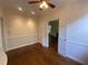 Another view of the bright bedroom with hardwood floors, large windows, and double doors at 629 Pinetree Dr, Decatur, GA 30030