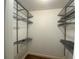 Walk-in closet featuring metal shelving and hardwood floors at 629 Pinetree Dr, Decatur, GA 30030