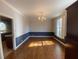 Sunny dining room featuring wood floors, classic chandelier, and stylish wainscoting at 629 Pinetree Dr, Decatur, GA 30030