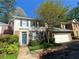 Traditional two-story home with blue shutters, an attached two car garage, and mature landscaping at 629 Pinetree Dr, Decatur, GA 30030