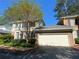 Traditional two-story home with blue shutters, an attached two car garage, and mature landscaping at 629 Pinetree Dr, Decatur, GA 30030